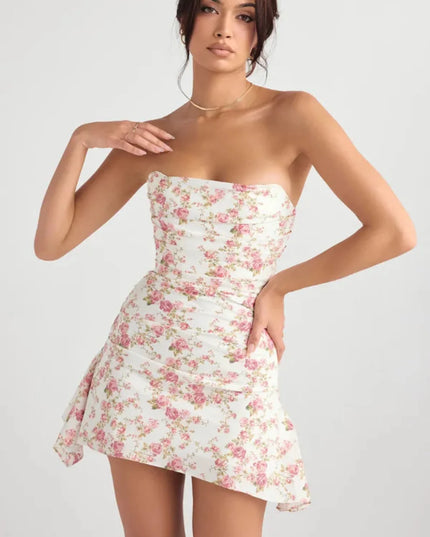 Front view of a floral mini dress with strapless neckline, fitted waist, and flowing side panel