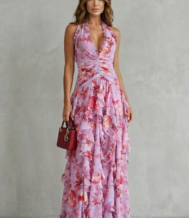 Front view of pink floral halter maxi dress with deep V neckline and flowing ruffles
