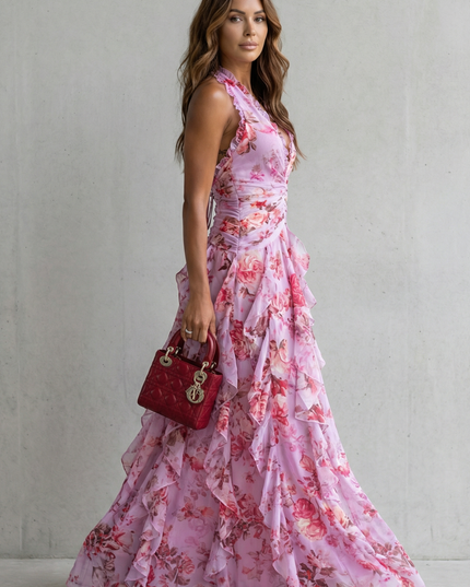 Side view of pink floral halter maxi dress showing fitted waist and tiered skirt