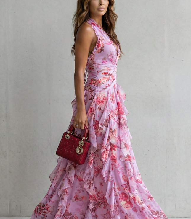 Side view of pink floral halter maxi dress showing fitted waist and tiered skirt