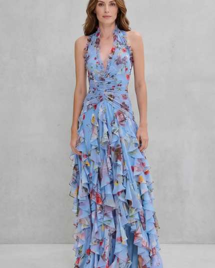 Front view of blue floral halter maxi dress with ruched waist and cascading ruffles
