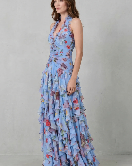 Side view of blue floral halter maxi dress showing flowing skirt and fitted bodice