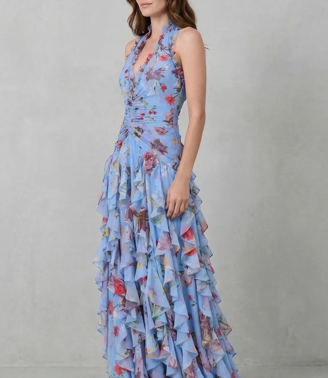 Side view of blue floral halter maxi dress showing flowing skirt and fitted bodice
