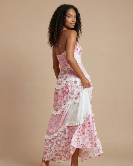 Back view of pink floral maxi dress showing open back design and tiered ruffled hem