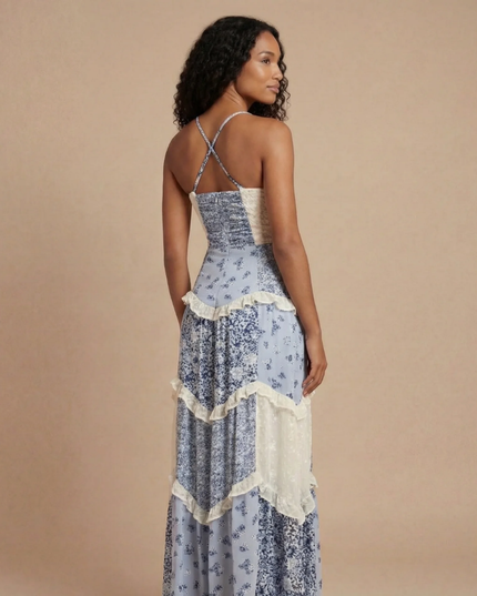 Back view of blue floral maxi dress with cross-back straps and cream ruffled tier details
