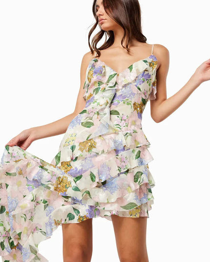 Close view of a floral wedding guest dress showing the V neck bodice and layered ruffle detail