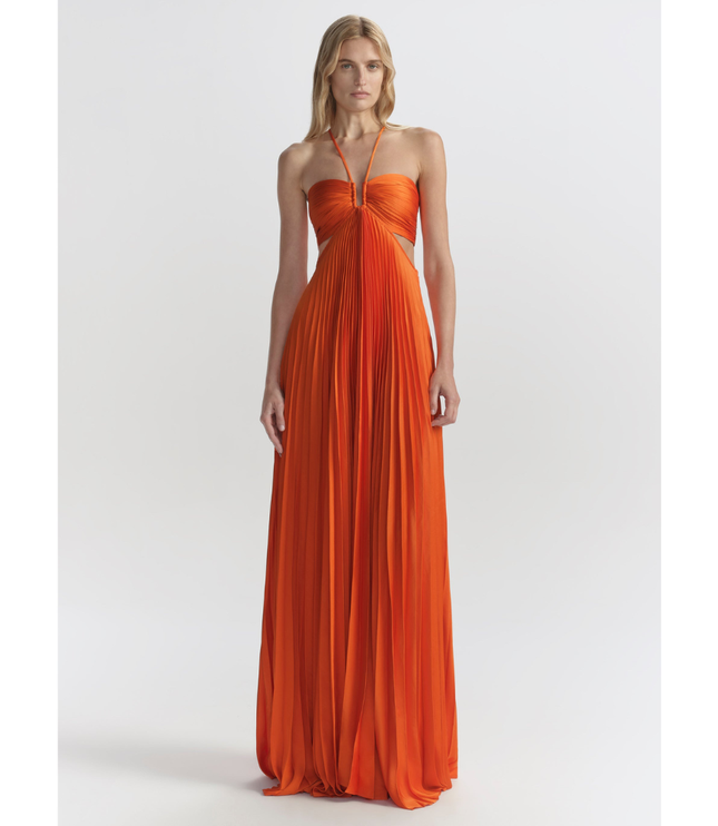 Bright orange halter maxi pleated dress with ruched bandeau bodice and side cutouts, front view