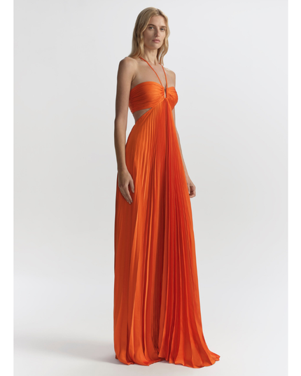 Orange wedding guest halter maxi pleated dress shown at 3/4 angle with flowy full-length skirt