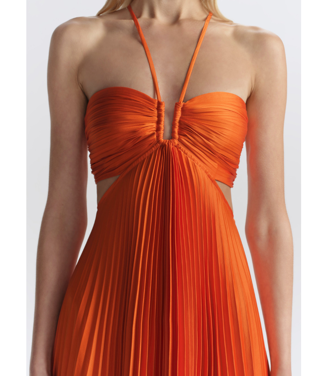 Close-up of orange halter neckline with ruched bust and pleated center panel on maxi dress