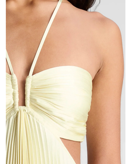Detail close-up of pale yellow ruched bust, halter straps, and side cutout on pleated maxi dress