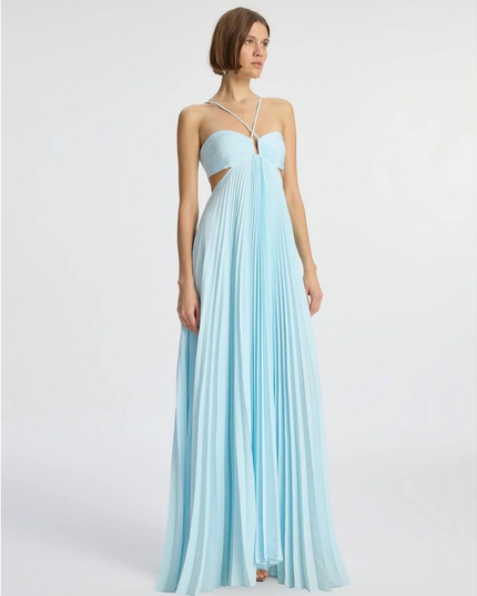 Light blue wedding guest halter maxi pleated dress shown at three-quarter angle with flowy skirt