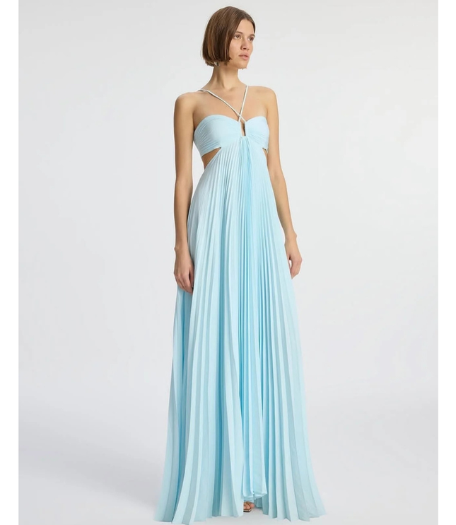 Light blue wedding guest halter maxi pleated dress shown at three-quarter angle with flowy skirt