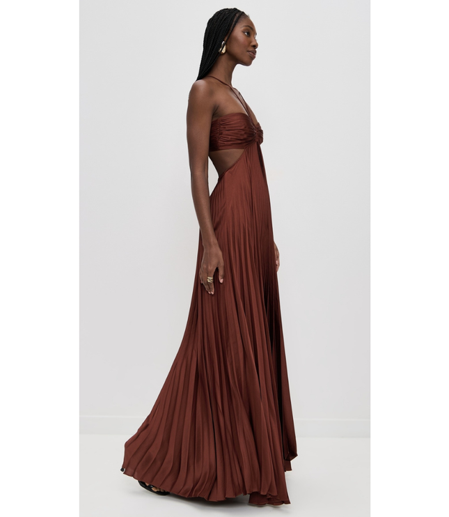 Side view rust brown halter maxi pleated dress showing waist cutout and draped full-length skirt