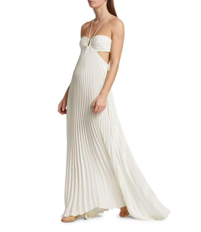 Ivory halter maxi pleated dress side view showing cutout waist and flowing skirt hem