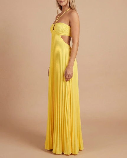 Side profile of yellow halter maxi dress with pleated details and side cutout