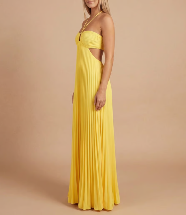 Side profile of yellow halter maxi dress with pleated details and side cutout