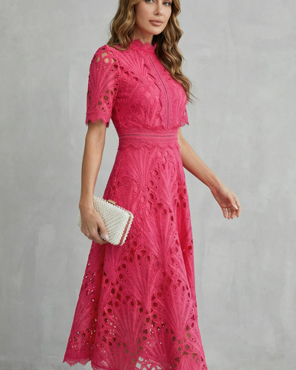 Side angle of pink lace midi dress showing short sleeves, high neck, and flared skirt