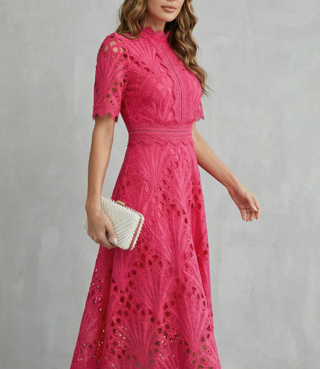Side angle of pink lace midi dress showing short sleeves, high neck, and flared skirt