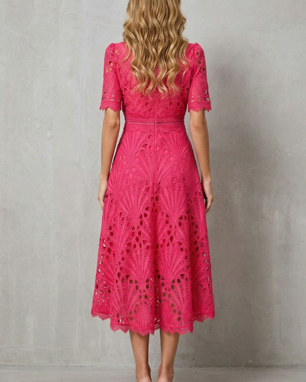 Back view of pink lace wedding guest midi dress with zip closure and scalloped hem