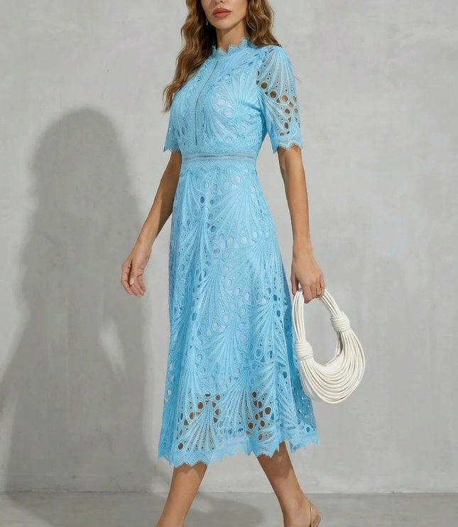 Side view of light blue lace midi dress with high neck, short sleeves, and flowing skirt