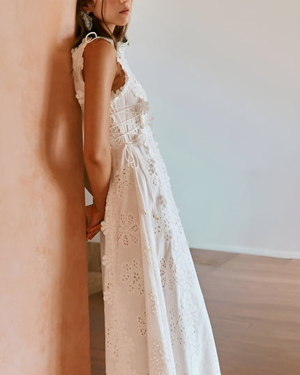 Back view of white eyelet maxi dress showing lace-up corset detail