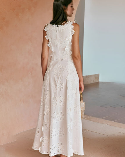 Back view of white eyelet maxi dress with ruffled armholes and cutout detail