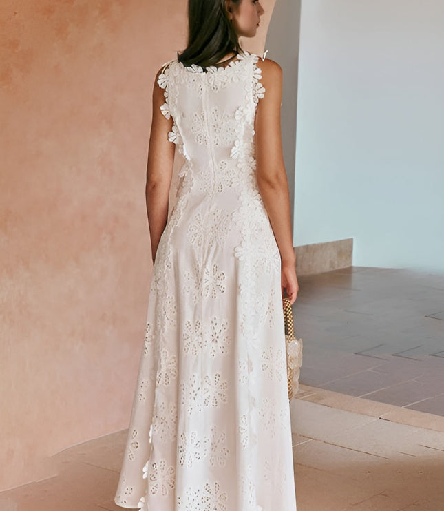Back view of white eyelet maxi dress with ruffled armholes and cutout detail
