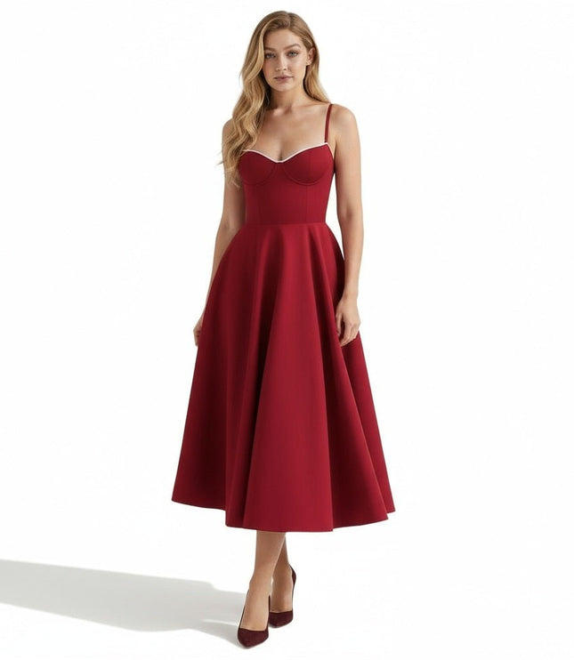 Front view of a burgundy midi dress with thin straps and a fitted corset-style bodice