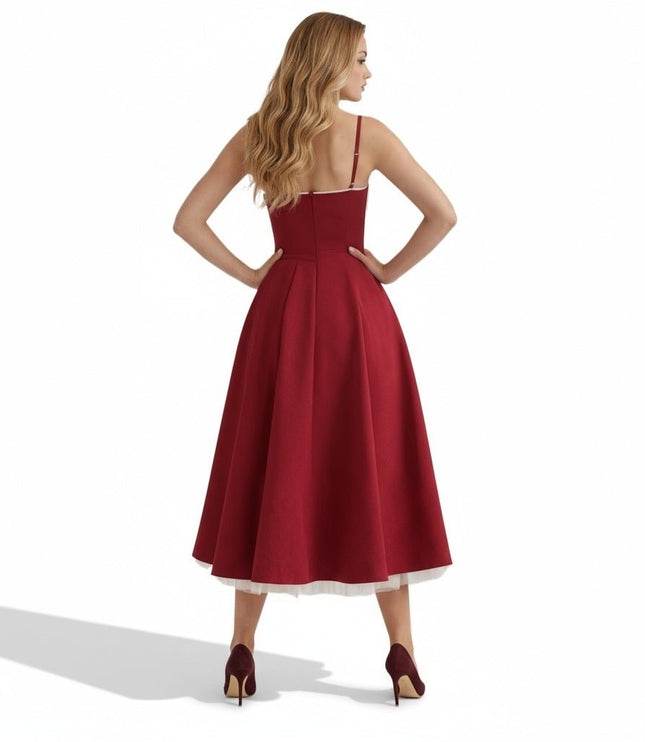 Back view of a burgundy midi dress with open back, fitted waist, and full skirt