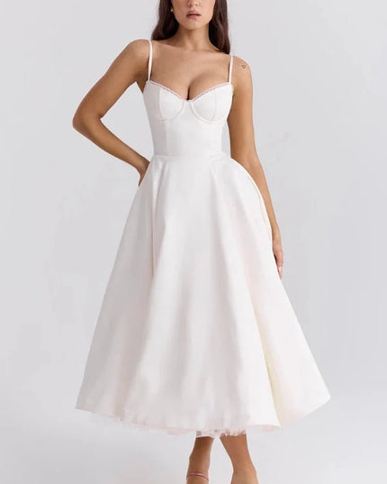 White midi dress with fitted bodice and full skirt for wedding guest