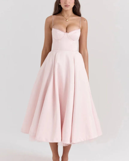 Blush pink midi dress with spaghetti straps and full skirt for wedding guest