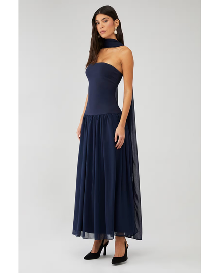 Front angled view of navy strapless maxi dress with flowing chiffon skirt