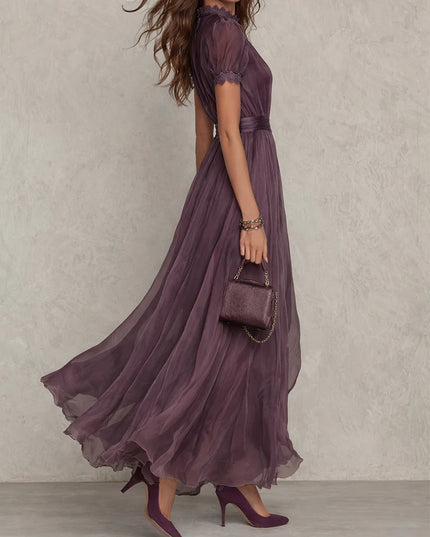 Side view of purple wedding guest maxi dress with keyhole neckline and sheer flowing skirt