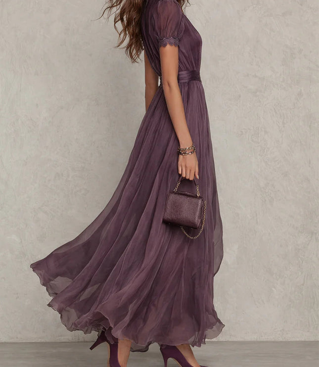 Side view of purple wedding guest maxi dress with keyhole neckline and sheer flowing skirt