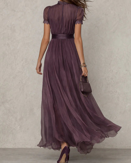 Back view of purple maxi dress with sheer short sleeves, fitted waist, and floor-length chiffon