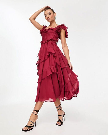 Close-up of blush pink ruffle midi dress showing textured bodice, square neckline, and layered trim