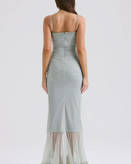 Back view of sage sheer maxi dress with fitted waist and ruffle hem
