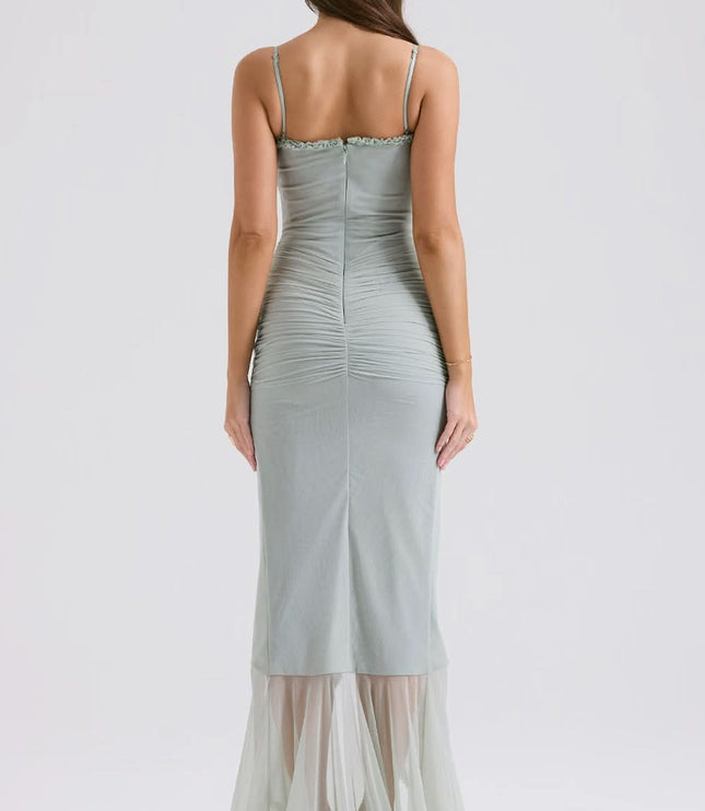 Back view of sage sheer maxi dress with fitted waist and ruffle hem