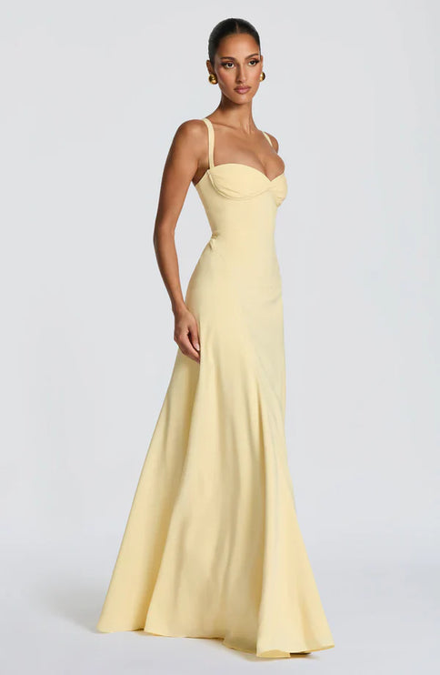 Side view of lemon yellow maxi dress with straps and softly flared skirt
