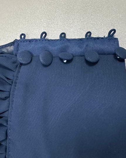 Close-up of navy beaded waist embellishment on floral maxi dress