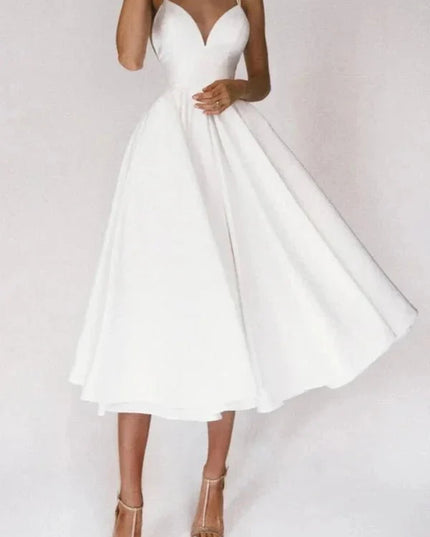 White V neck midi dress with thin straps and flared skirt for wedding guest