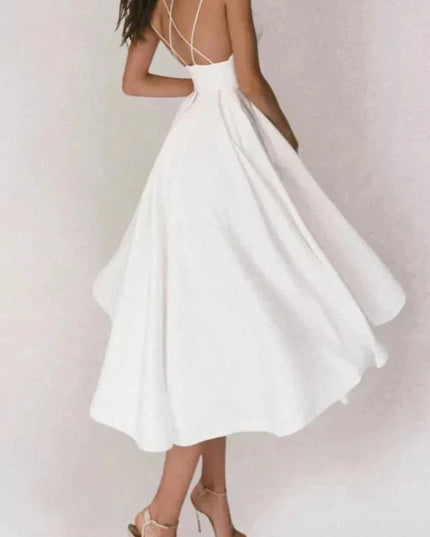 White backless midi dress with flowing skirt and crisscross straps