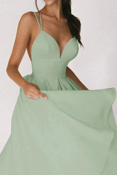 Front view of mint green wedding guest midi dress with deep V neck and full skirt
