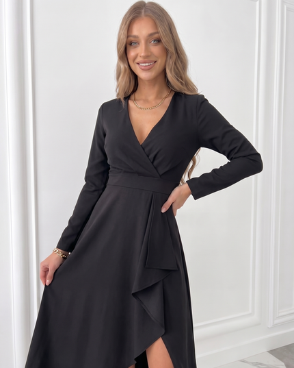 Black midi wedding guest dress with wrap front, long sleeves and elegant draped slit skirt