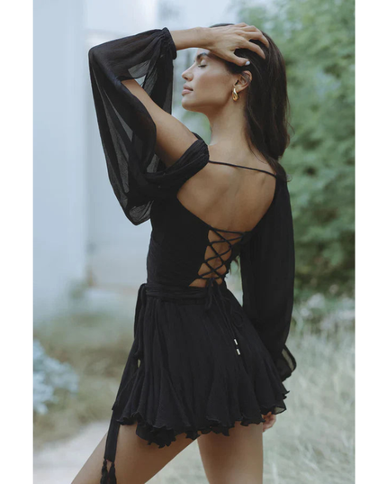 Black wrap mini dress with long sleeves, open back lacing detail