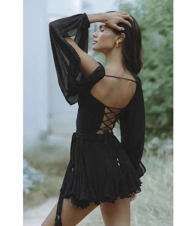 Black wrap mini dress with long sleeves, open back lacing detail